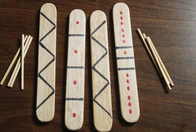 b) What is the probability that the sum is a multiple of three? c) What is the probability that the product is a multiple of four? E MAH LINK he stick game uses four flat sticks.