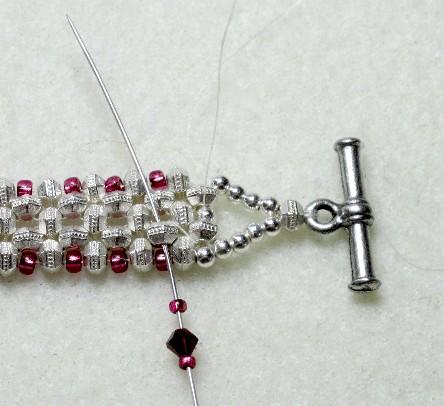On your bottom needle, put one size 15 seed bead, one 3mm crystal and one size 15 seed bead.