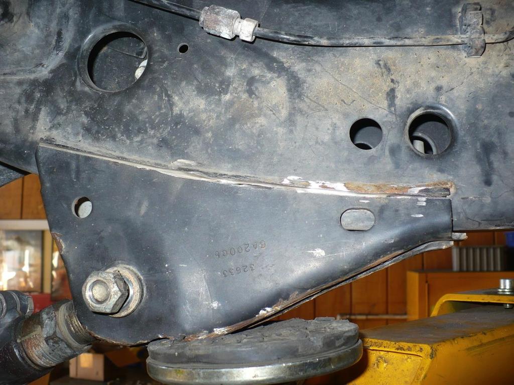 3) Using a cut-off wheel, cut the sides of the lower control arm bracket as