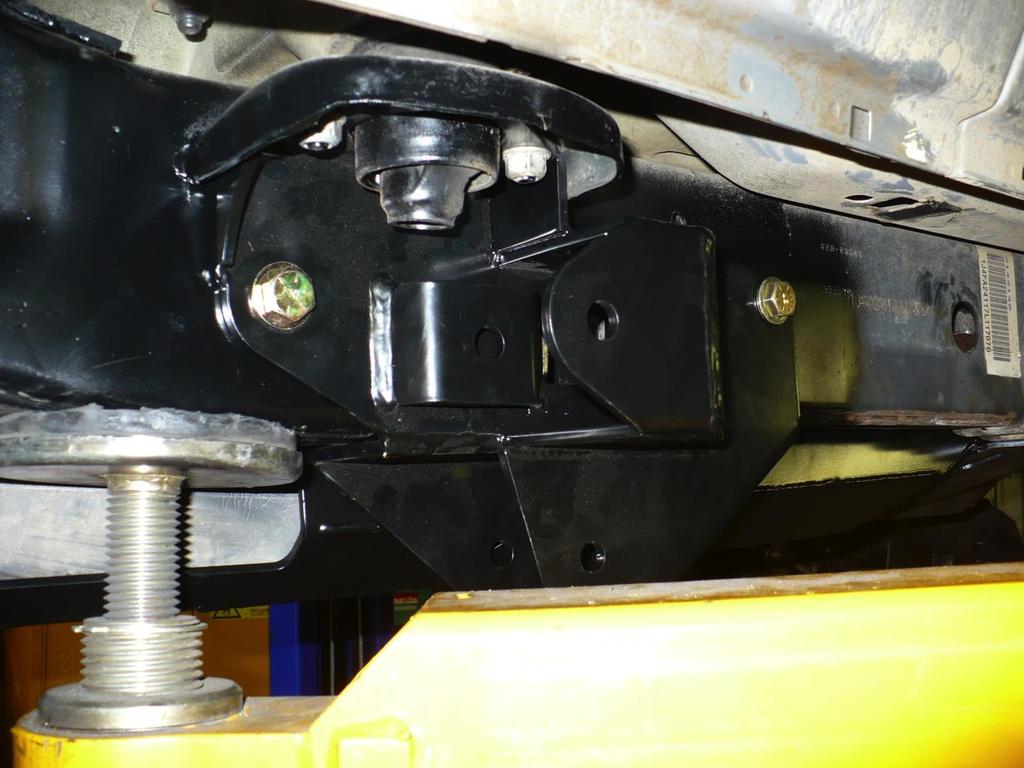 INSTALLATION OF REAR CONTROL ARM BRACKETS 9) Remove the two body mount nuts and the large center body mount bolt.
