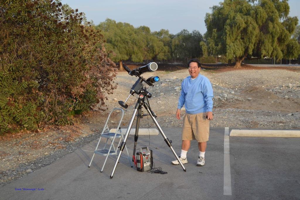 Top Photos shows Todd Kunioka setting up his telescope to see the