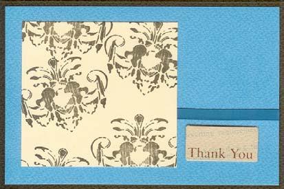 Attach the Blue I Love You die cut to a Tan die cut file folder, and layer the folder onto the panel. Hold folder closed with a photo turn and brad. 3.