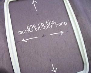 Spray the back of a piece of stabilizer and place it on the back of your fabric, where the hoop will be.