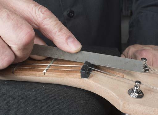 Depending on your playing style, and how perfectly level your fret tops are, a neck should be anywhere from perfectly straight to having 0.012" of relief.