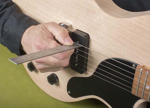 Adjust the pickup height One at a time, hold the low and high E strings down at the 22nd fret.