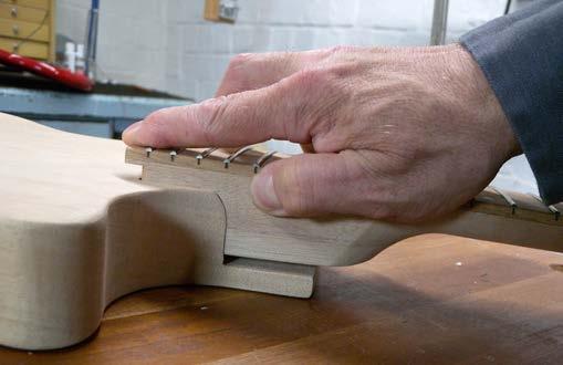Press the neck straight down from the top until seated all the way down into the mortise and clamp without glue.