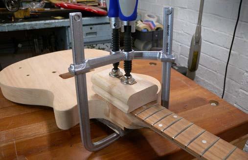 There will be some small gaps and chips around the joint; this is normal for a production guitar. These will get filled when you prep for finishing.