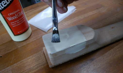 Spread the glue generously over the sides and bottom of the tenon and the bottom of the mortise. Install the neck as you did during the dry test fit.