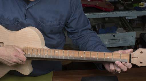 If the fret ends feel sharp where they meet the edge of the neck, gently sand them back with 320-grit sandpaper using long strokes down the length of the neck.