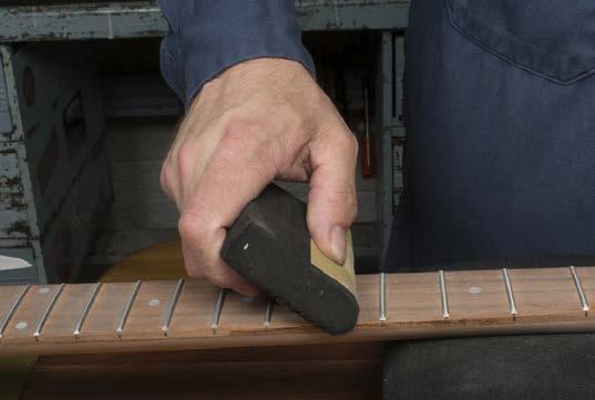 Use a fret crowning file to restore their rounded shape. Reapply blue marker to the fret tops.