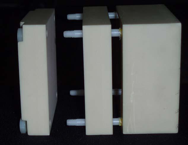 A cubic film block (6.35 cm on each side) capable of holding film at two locations (25% and 50% across the block width) was used in this study (see Figure 2.2 (a)).