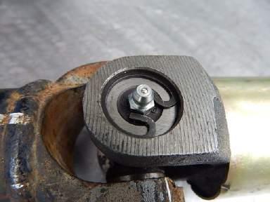 If this happens, install an OEM style snap ring on the bearing cap that has the grease fitting in it and a