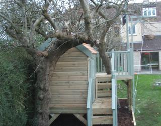 constructed around an existing tree. This platform accommodates a rope ladder and a climbing wall with knotted rope.