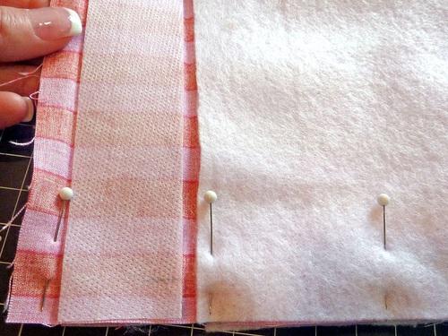 Be extra careful to align the top creases and the side edges of the pockets. Pin in place along both sides and across the bottom. 7.