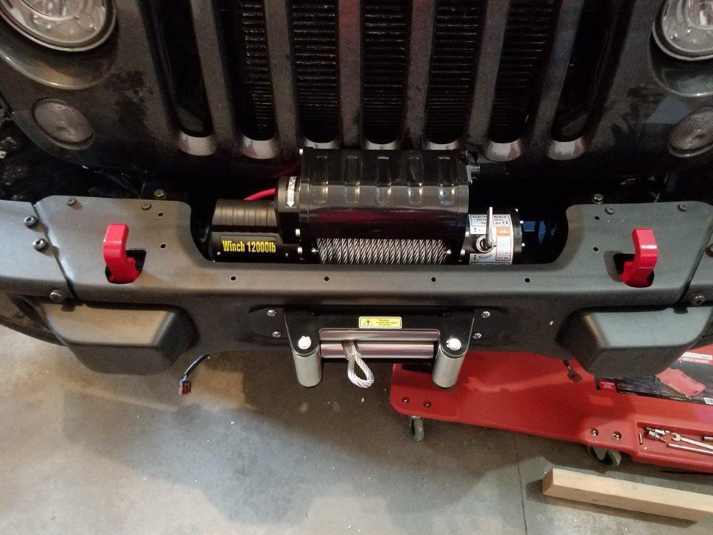 22. Lift the bumper by the tow hooks and place it back on the Jeep.