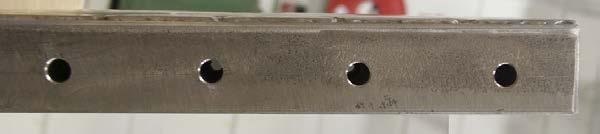Figure 3 Evacuation holes are drilled in the end stops of the tension-plate.