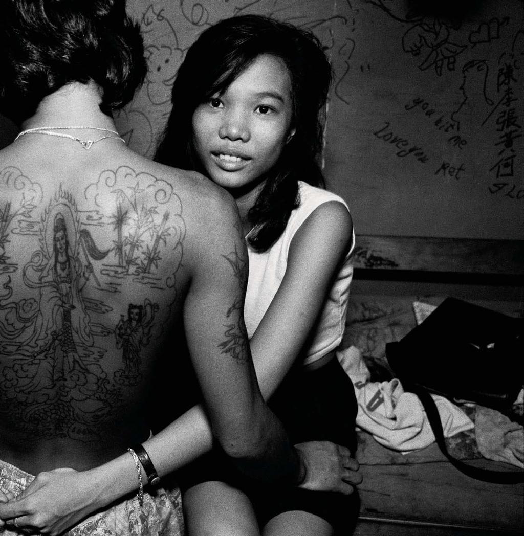 Portrait of a young prostitute with her boyfriend, a Triad member, Hong Kong, 1988.