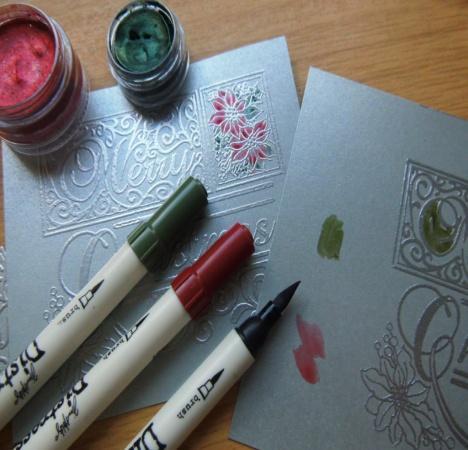 Here the Cosmic Shimmer lava red watercolour has been used along with the holly green watercolour.