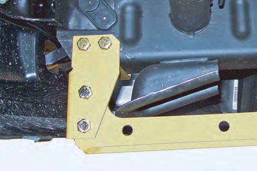 from the kit through the front holes. Push the bracket up tight to the frame, then drill a / inch diameter hole into the frame through the rear inner hole of the bracket. PHOTO NO.