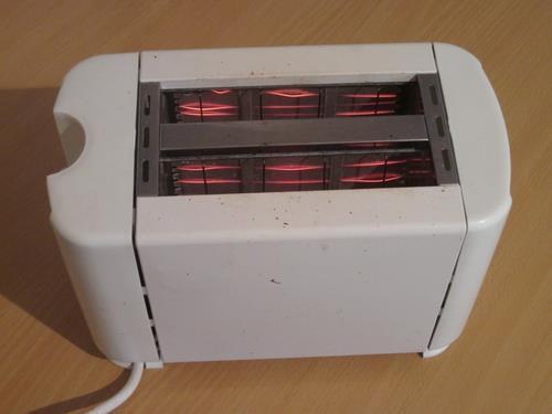Look at the following photo of a toaster. Can you see the glowing filament inside?
