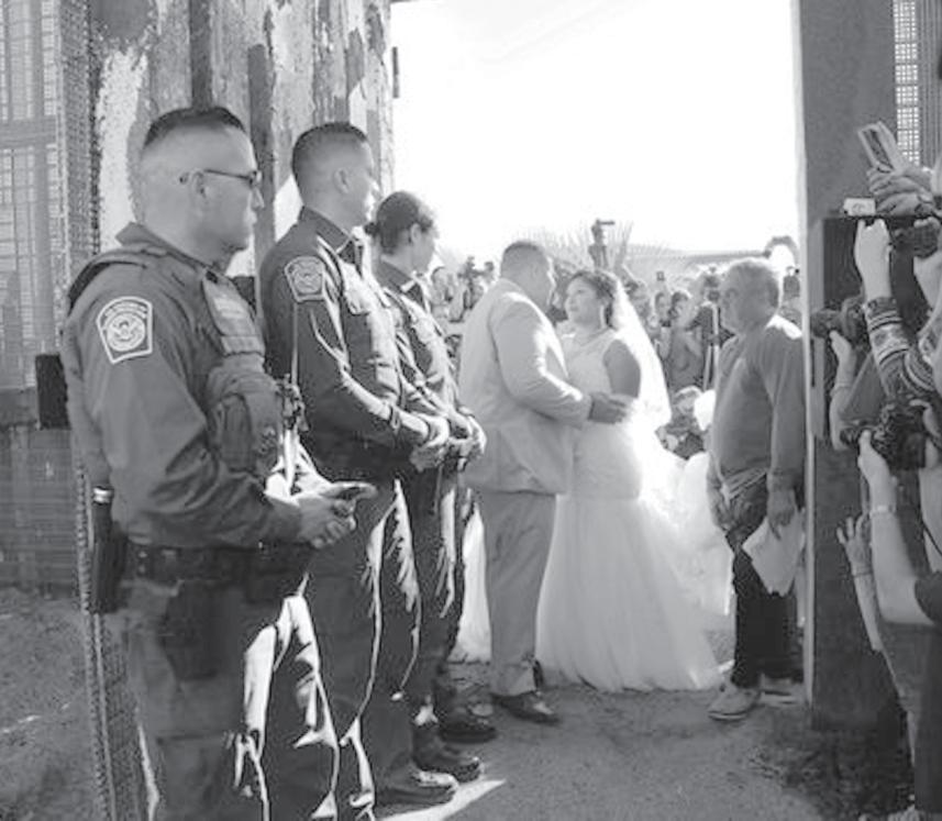 18, Brian Houston of San Diego and Evelia Reyes of exico signed official Tijuana documents making them husband and wife and then embraced between the doors of a steel border gate that is opened for