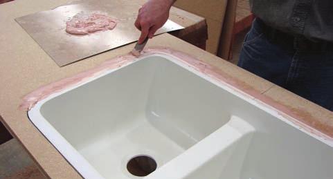 Flip countertop over then screw in or glue and staple wood strips as supports to the underside of the opening.