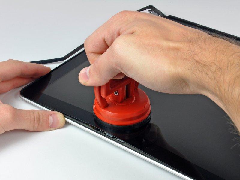 Attach a suction cup near the top edge of the glass display panel and use it to pull the glass panel up