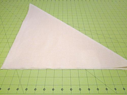 3. To find the true bias, fold the square at a diagonal. Press the fold in place. 4.