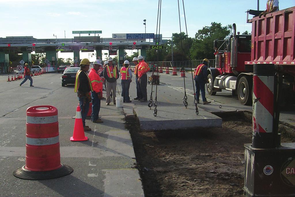 Figure 8.22. Slabs being removed using the lift-out method. Notice the spalls on the edge of the remaining pavement on the left caused by the lifting operation. Figure 8.23.