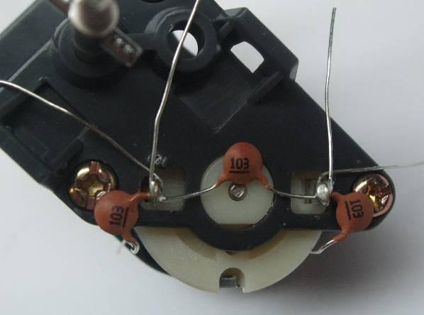 44, attach two more ceramic capacitors for a total of three, feeding their leads through the holes in the