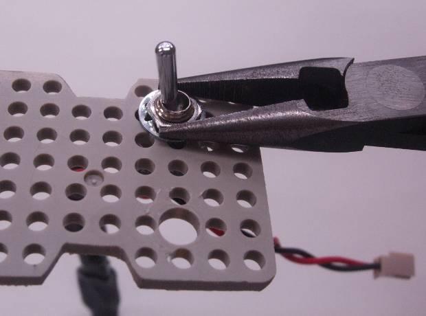 With the underside of the servo support plate facing upward, align the protrusion of the flat washer to prevent turning