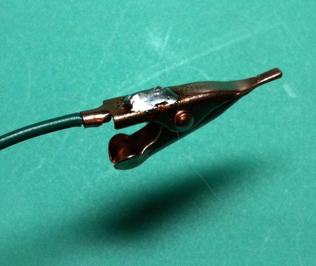 Next, we'll solder the alligator clip to the end of the ground wire.