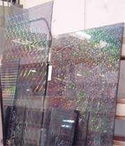 Hologram Glass/ Holographic Glass Our Hologram Glass is produced by sandwiching a hologram film between two layers of glass. Hologram film is a record of electromagnetic wave vibration.