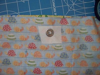 (Should be about 6.5 inches.) Measure 1.5 inches down and make a mark. Then taking the magnetic snap, mark where the prongs will push through the fabric.