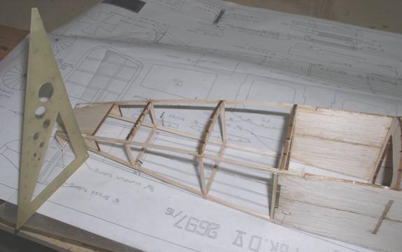 Make a part from 1/32 plywood and glue to the fuselage. Add the 5 1/16 x1/8 stringers to the rear section.