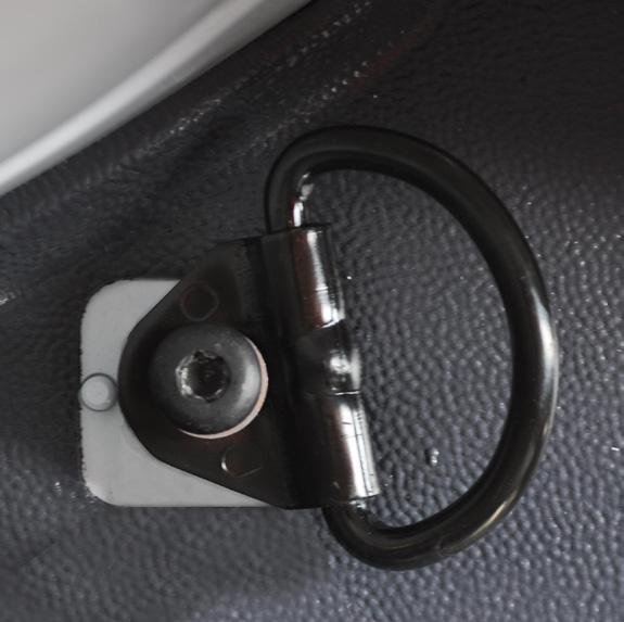 From mid-area of cargo area by each sides wheel well remove a bolt