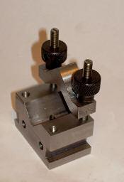 The picture show the work laying on top of the first clamp, with 3 holes drilled and a