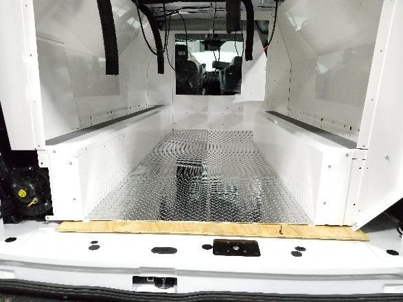 Slide diamond plate floor into van.