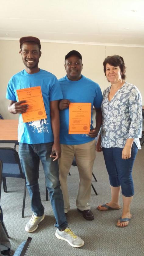 Onder: Karen besig om prakties te wys wat om te doen Links: Baie trotse Tshepho en Simon ontvang hul sertifikate by Karen (William