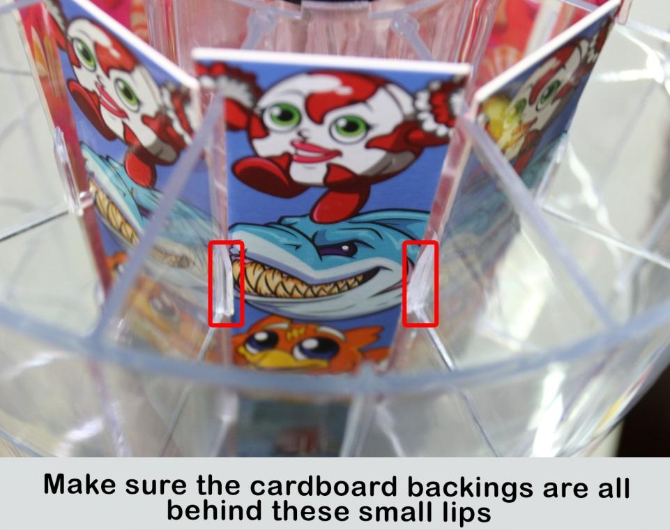 Note: Notice the lip inside each of the slots; make sure the backing is behind the lips so that the toys won t get