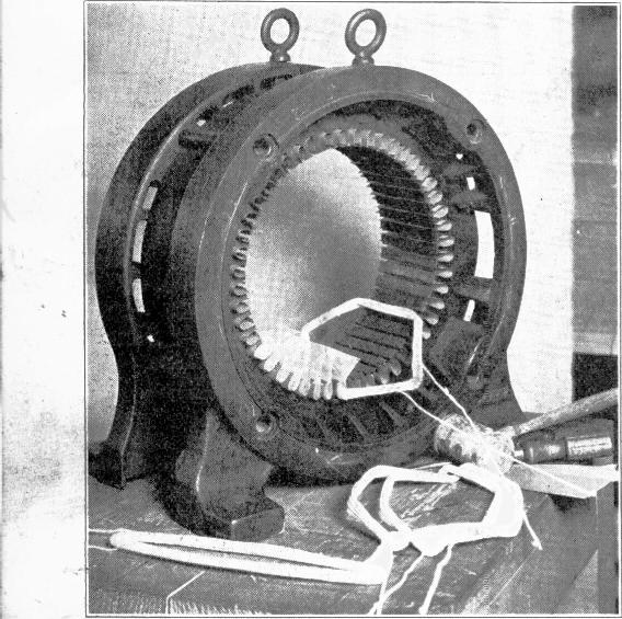 After the slots have been insulated, begin by placing one side of the first coil in any slot with the leads of the coil toward the winder, as shown in Fig. 62.