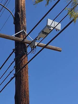 Below is an example of an acceptable radio and antenna strand-mounted on aerial fiber optic cable: c. City-owned streetlights.