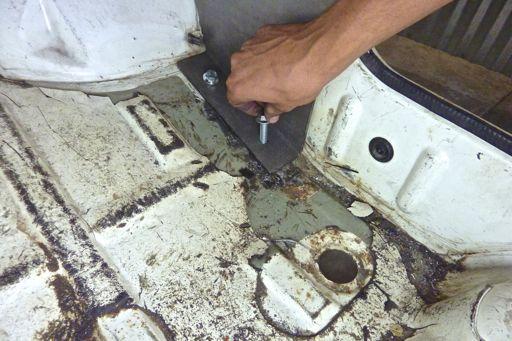 Caution: Be sure to look below the floor panel to insure you are not drilling into any brake lines, fuel lines or
