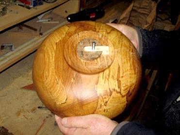 A simple softwood slip with a matching dovetail profile and a bolt through it would then slide into the base of the bowl.