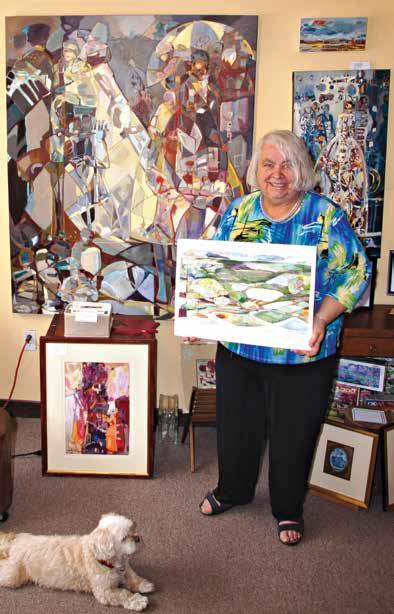 Hedi Nowak, owner of The Gallery Upstairs in Milton, holds a