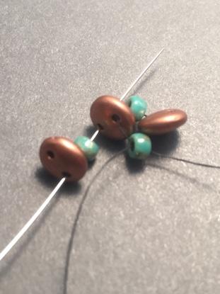 Step 6: To finish the round, pass through the 8/0 bead from the base row.