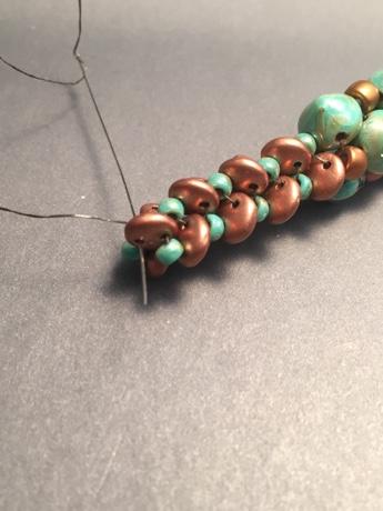 Pick up ONE 8/0 bead and pass directly through the 8/0 bead, which is the