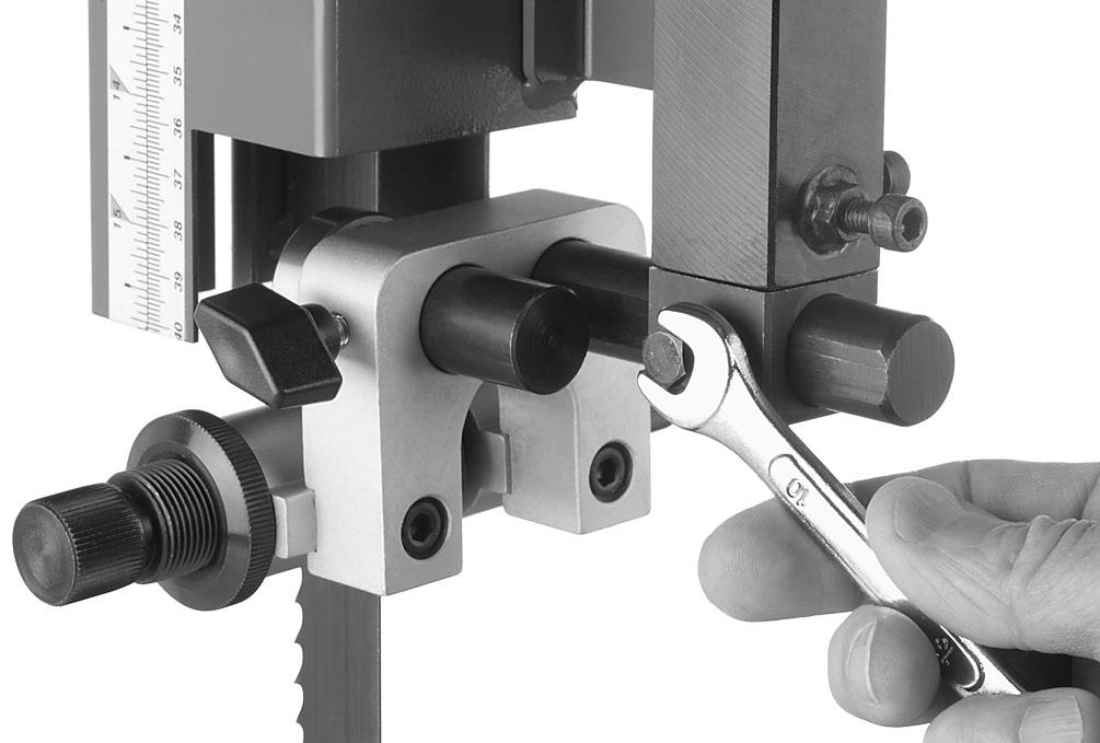screw (see Figure 5). Upper Blade Guide Shaft Figure 7. Loosening lateral adjustment bolt. 8.