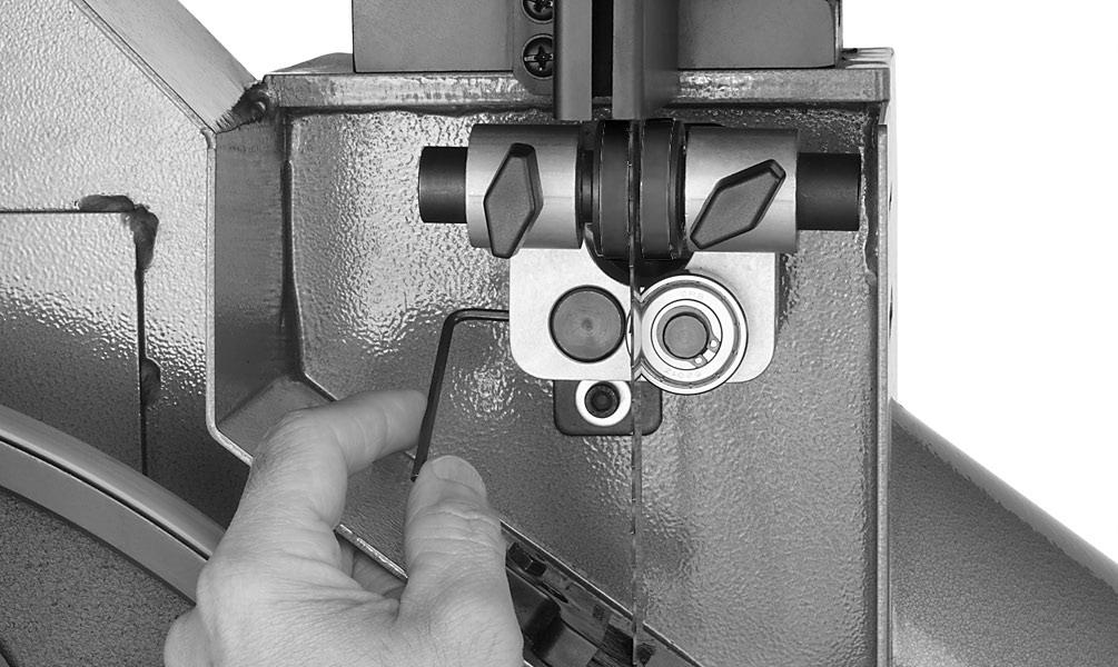 Position the front of the adjustment rod flush with the face of the guide block, then tighten the set screw on the left side of the block, as shown in Figure 13. 5.