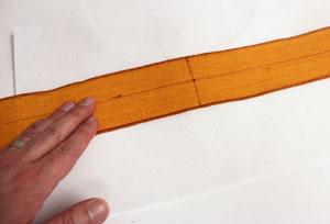 To get ready to embroider the ribbon, cut a piece of medium weight cutaway stabilizer a bit